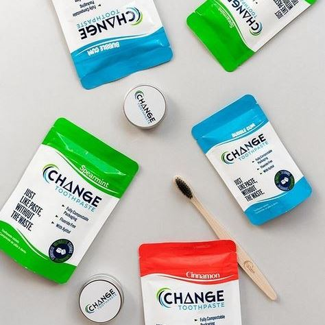 Canadian made Change Toothpaste tablets, travel tin and charcoal bamboo toothbrush on a white background