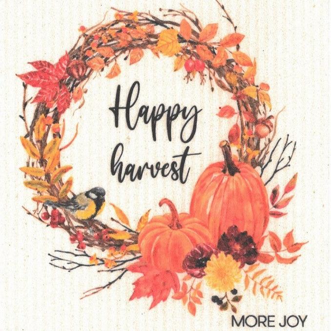 Happy Harvest More Joy dishcloth with autumn leaf print, woven cotton fabric, 8x8 inches, in warm orange and brown tones by