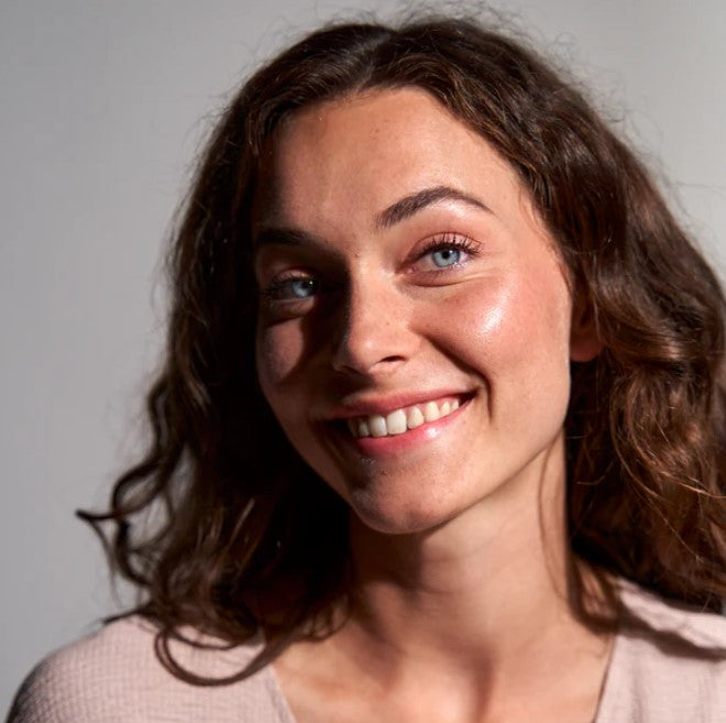 Close-up of the Birch Babe Skinny Dipper Lip and Cheek Balm tube cap featuring eco-friendly embossed logo detail on soft