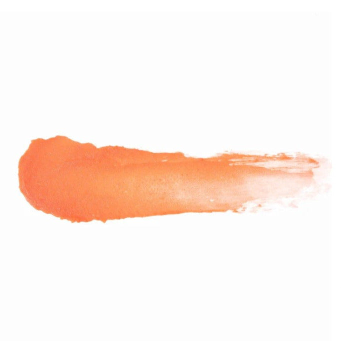Close-up of the Sunset Seeker Lip and Cheek Tint tube cap with natural coral hue and matte finish, highlighting sleek