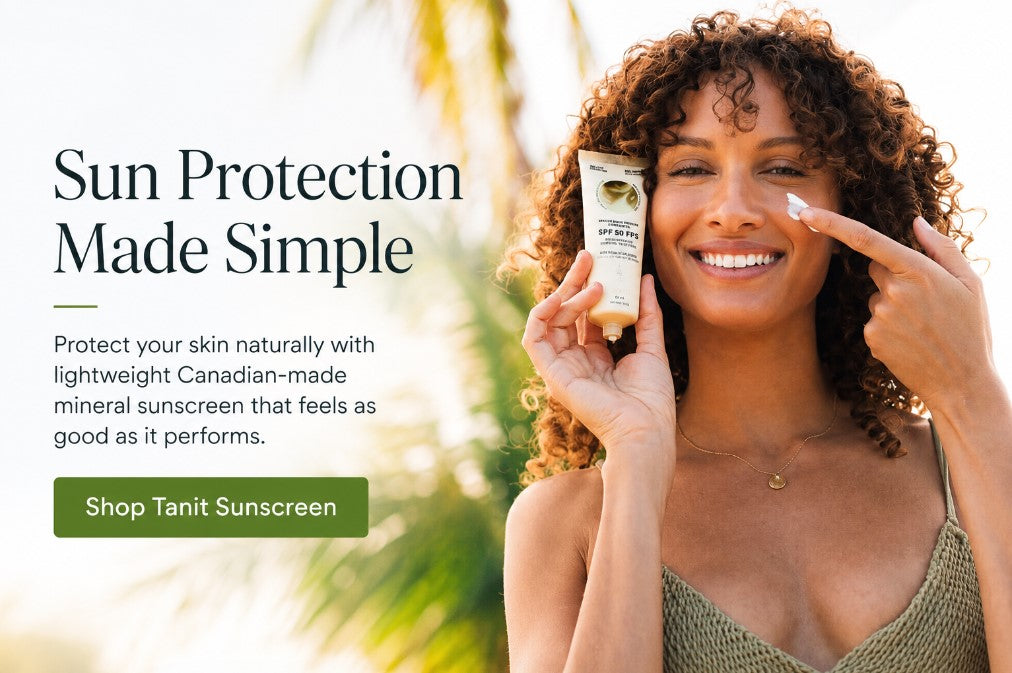 Woman applying Tanit Botanics SPF 50 natural mineral sunscreen with Canadian-made sunscreen tube against a tropical summer background.