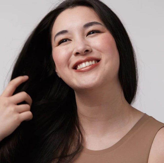 Close-up of vintage rose tint tube cap with textured embossing, highlighting natural color and elegant design details.