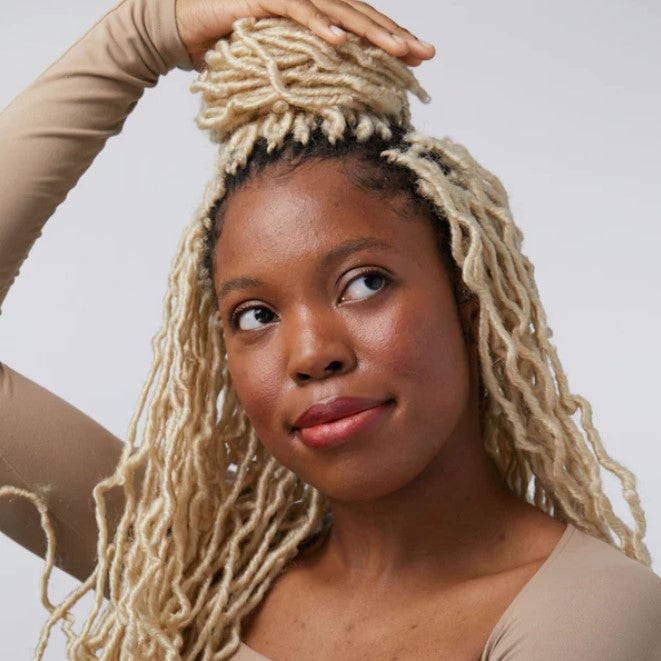 Close-up of the lip and cheek stain’s textured, creamy formula with visible natural ingredients and a subtle warm tint on