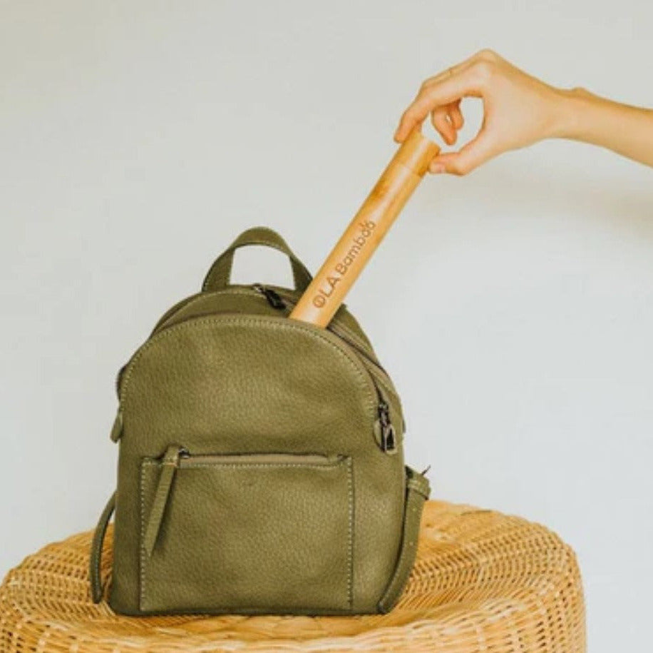 Close-up of the bamboo travel case’s textured surface and sliding latch mechanism in matte finish, showcasing durable