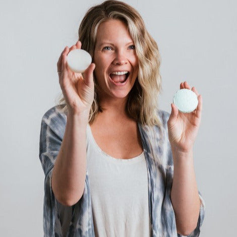 Close-up of the travel-sized Clear Shampoo and Conditioner bottles featuring textured labels and compact, portable packaging