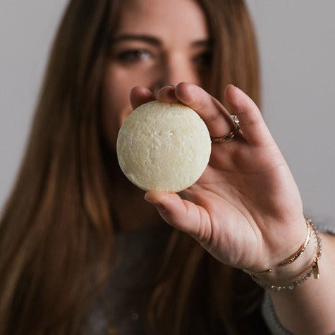 Close-up of the travel-sized bottles showing textured, lavender-scented formula with clear label details for be YOU Shampoo