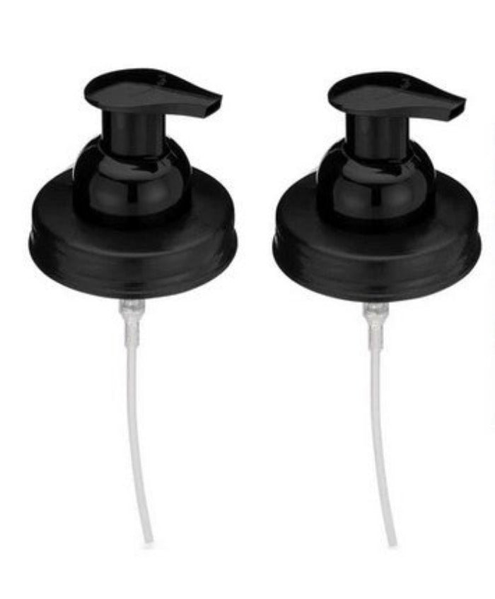 Set of two black foaming hand soap pump mason jar lids on a white background