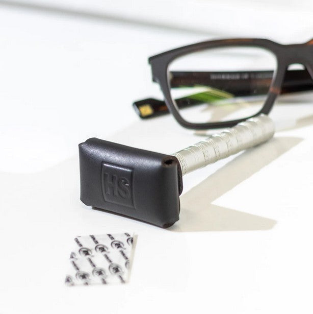 Henson Razor inserted into black leather head cover showing secure snap fastening