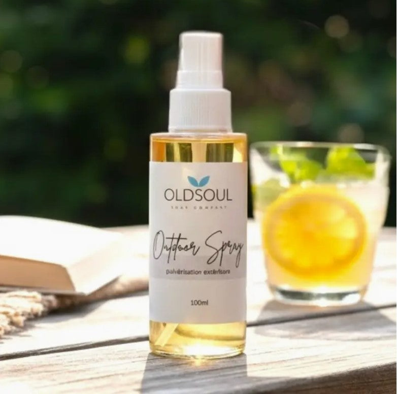 Happy Camper Outdoor Spray by Old Soul Soap Company, Canadian-made natural bug spray in glass bottle on picnic table