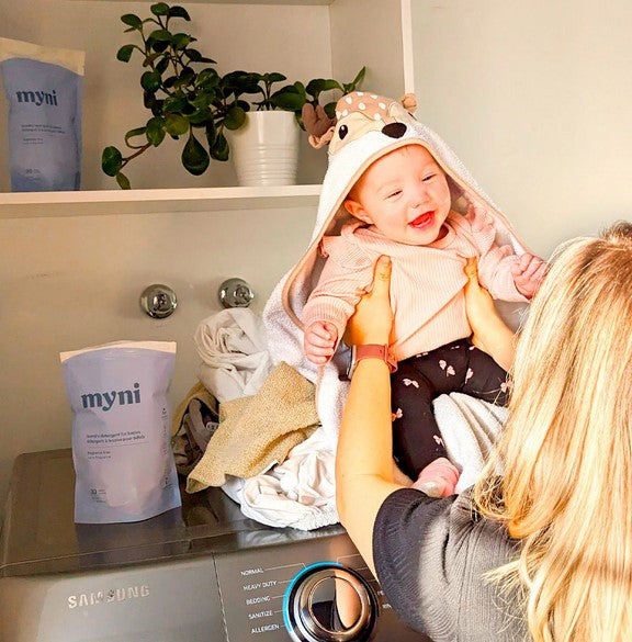Close-up of Myni Baby Laundry Detergent label highlighting the gentle, hypoallergenic ingredients and eco-friendly packaging