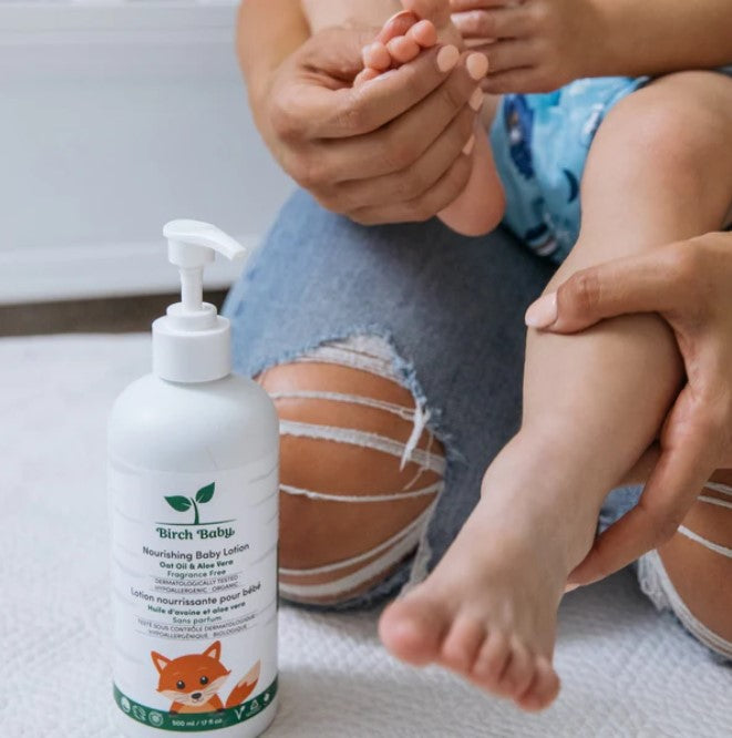 Close-up of Birch Baby Nourishing Lotion tube highlighting the soft, textured label and soothing scent notes on the packaging