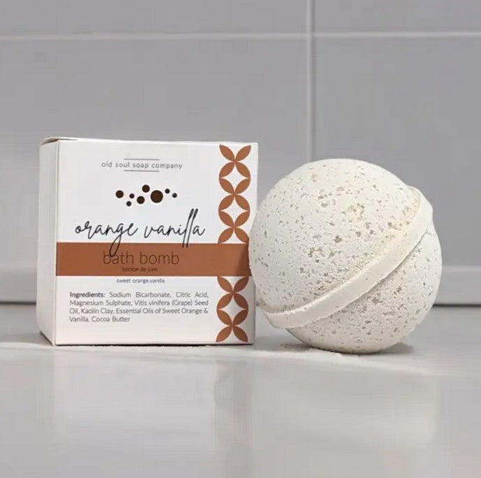 Old Soul Soap Company orange vanilla bath bomb with textured orange and creamy vanilla swirls, round shape, and subtle