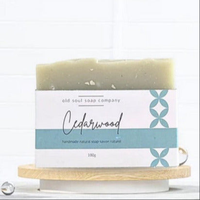 Close-up of the gift box’s textured white ribbon bow and green wrapping paper accents on the Winter White & Green Soap Gift