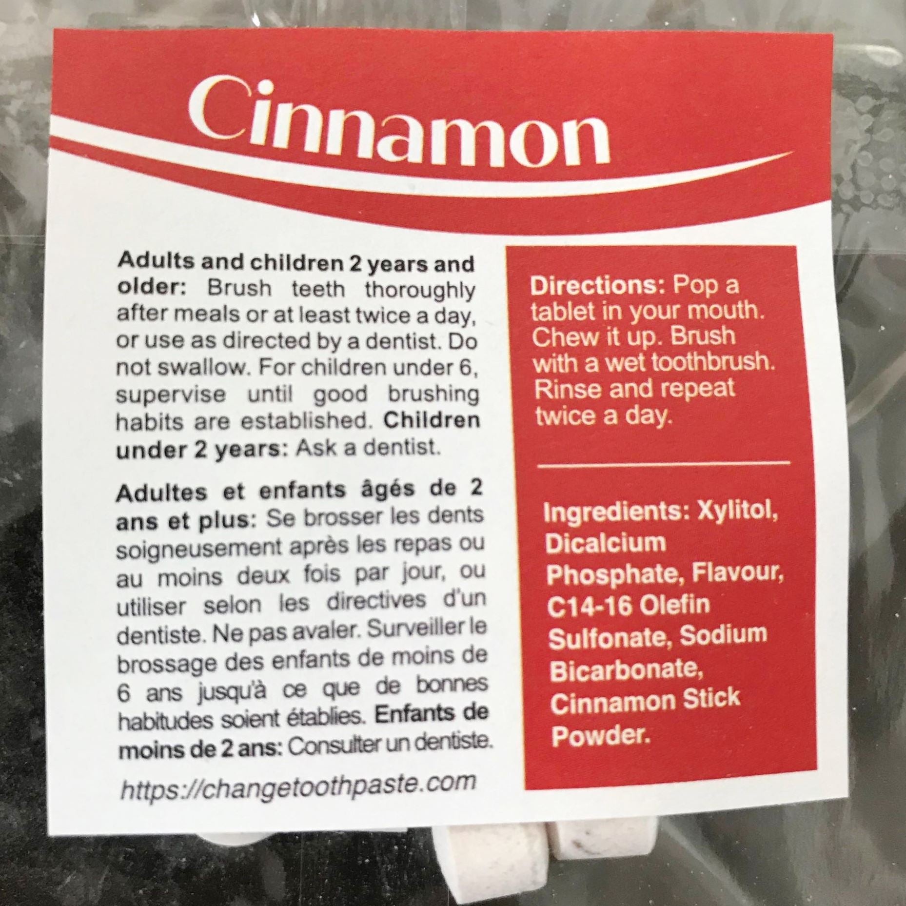 Close-up of cinnamon-scented toothpaste tablet pack showing textured surface and clear label detail for easy identification