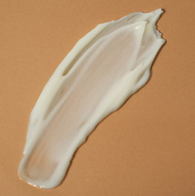 Close-up of the Body Quench - Chantilly lotion bottle's sleek texture and elegant label, highlighting the soft pastel