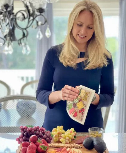 woman holding charcuterie Wet-It Swedish cloth in kitchen eco friendly reusable sponge cloth lifestyle entertaining kitchen scene
