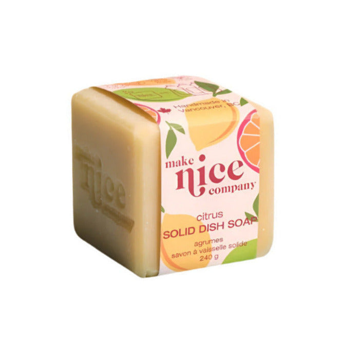 Citrus solid dish soap bar with textured surface and bright yellow color, branded by Make Nice Company, biodegradable and