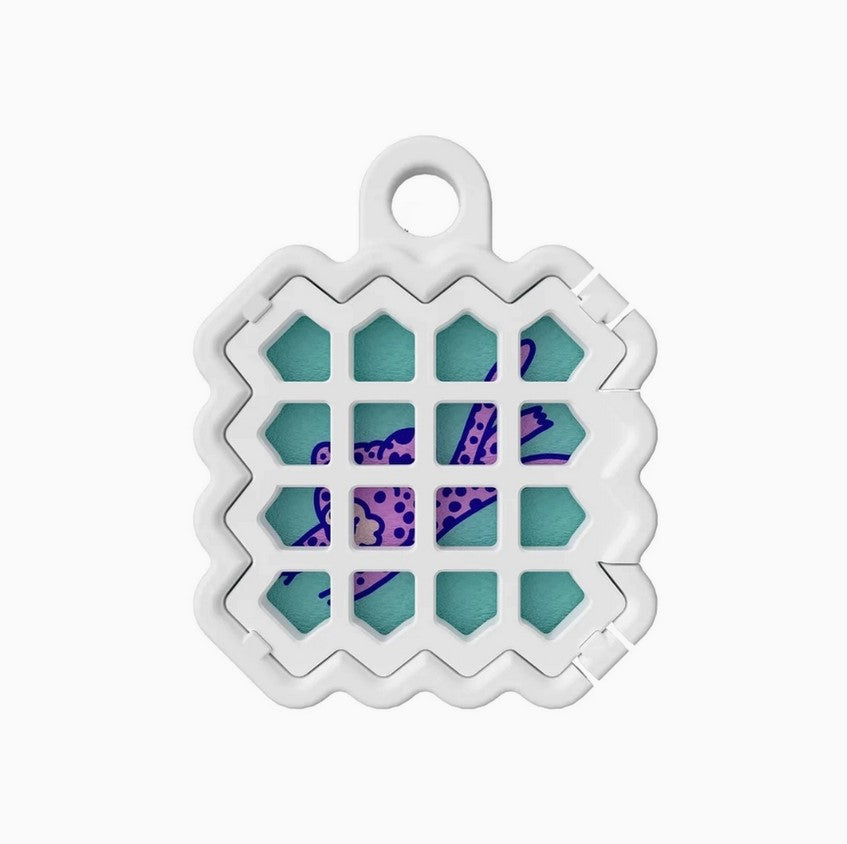 Close-up of the NATPAT Pet Locket’s textured rubber surface and subtle engraved logo on the back side