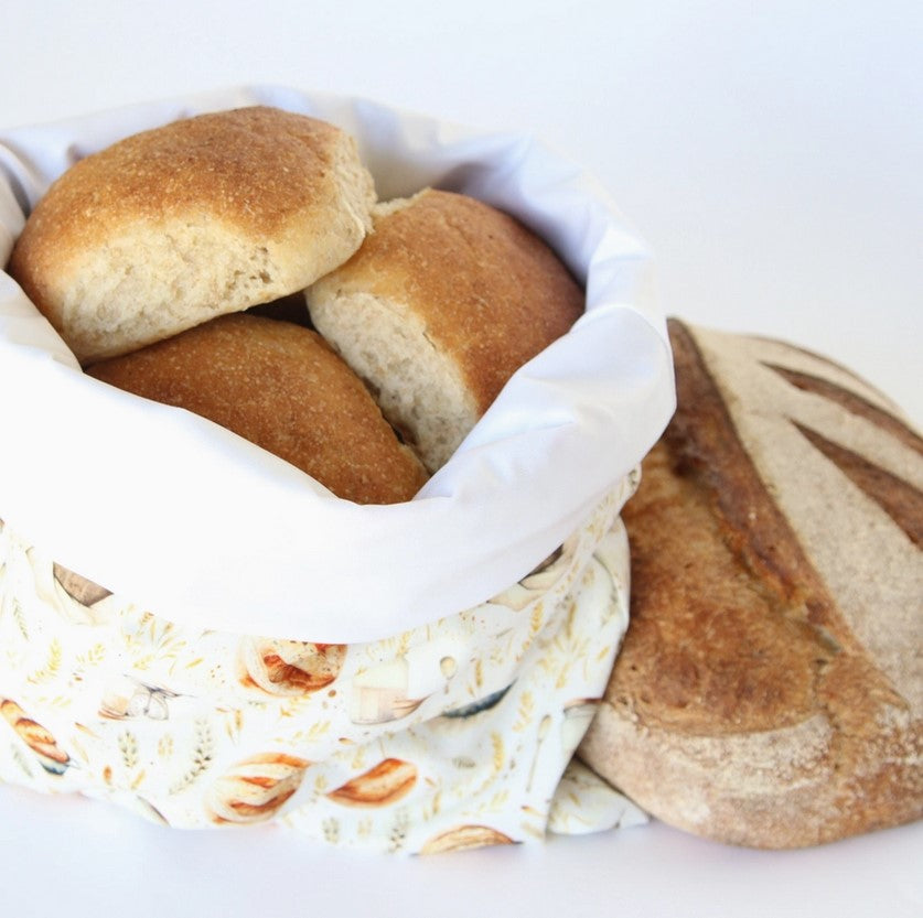 Colibri reusable bread bag with sourdough print holding fresh homemade buns and bread