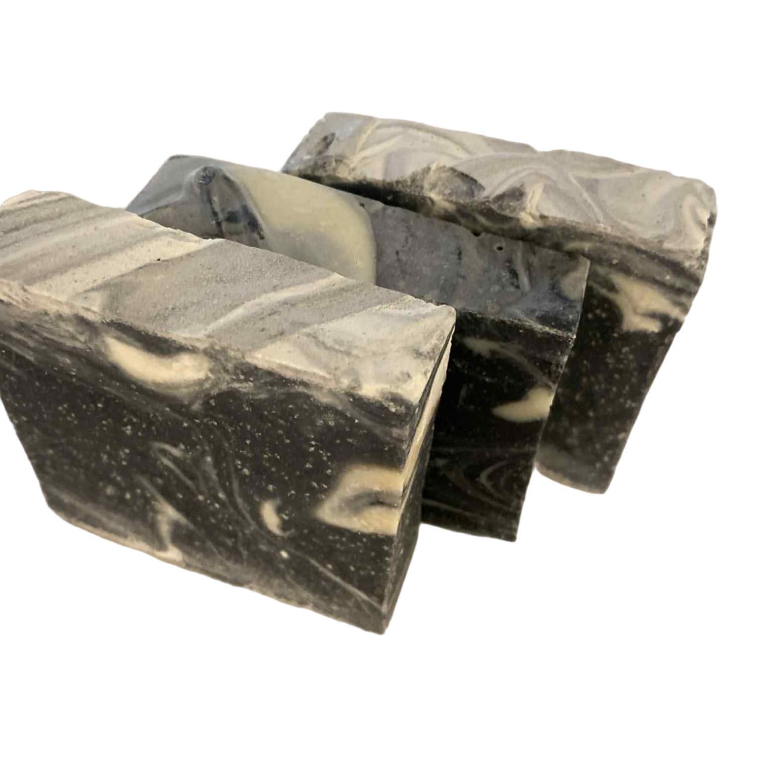 Close-up of the Dirty Boy Scrub artisan soap’s textured surface with rugged, earthy details and visible branding on the