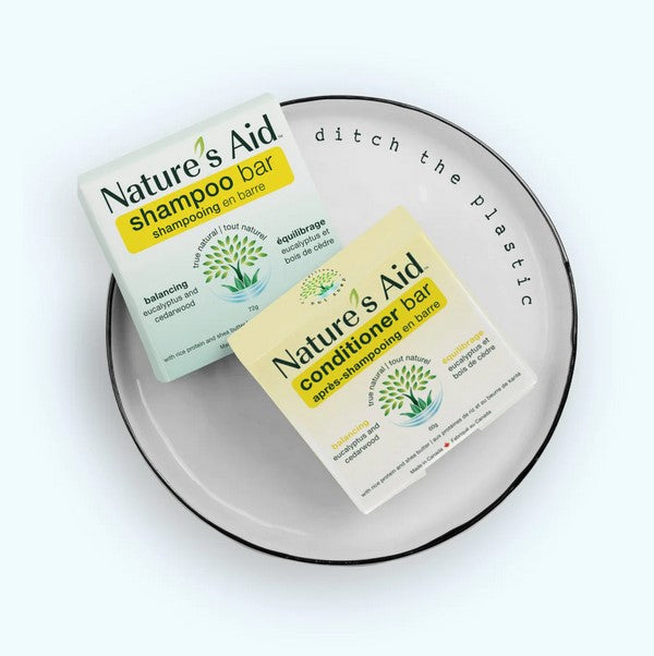 Close-up of the shampoo bar’s textured surface with visible eucalyptus and cedarwood grains, highlighting its natural