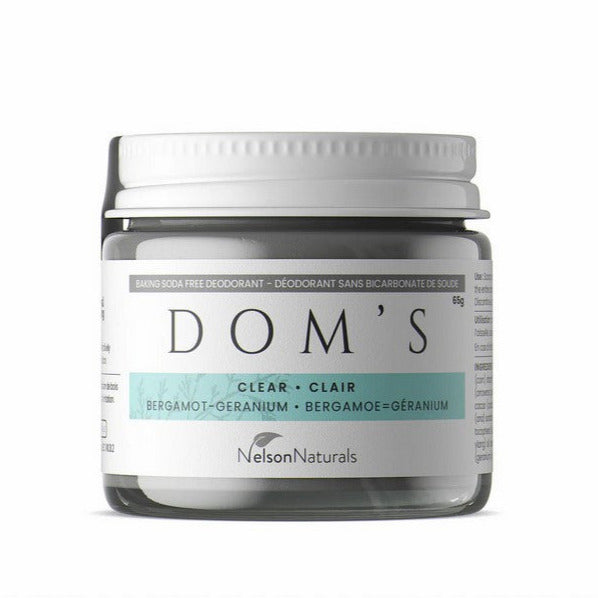 Dom's Deodorant Baking Soda Free paste in a clear glass jar with bergamot and geranium botanical ingredients, textured