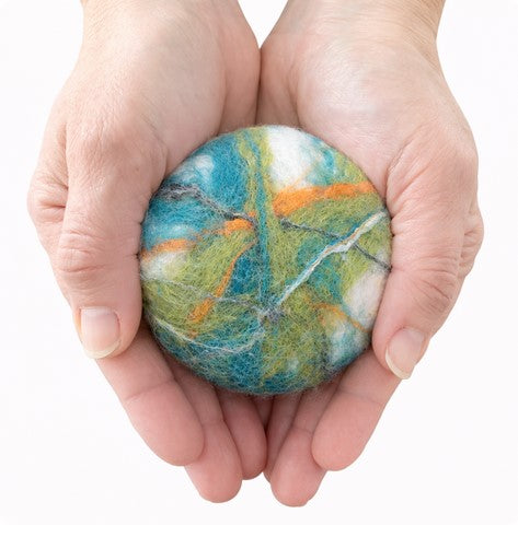 SNC felted cedar sage bar soap in a earth tones pattern in hands