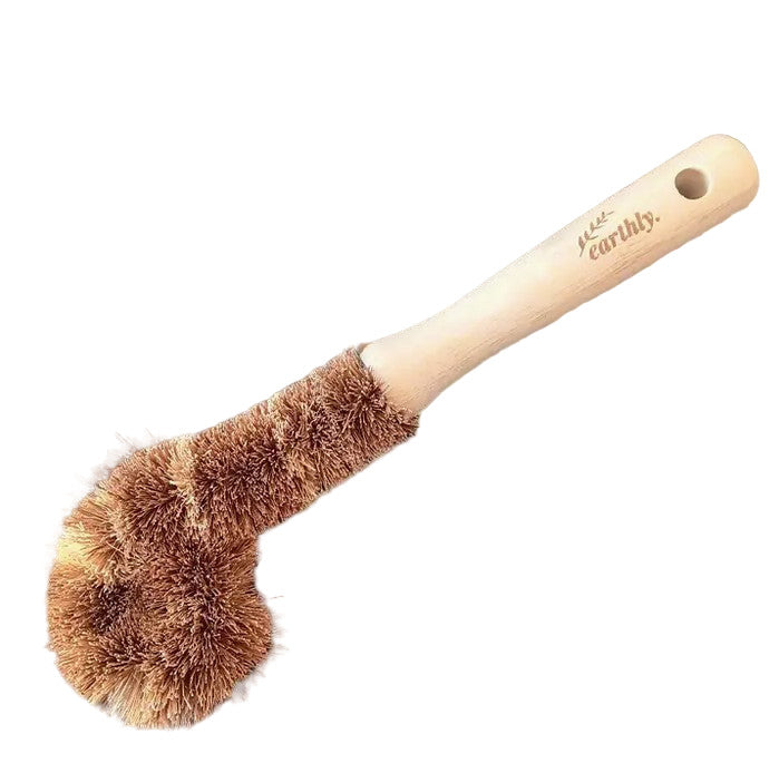Close-up of a compostable cleaning brush's textured wooden handle and durable bristles for scrubbing stubborn grime