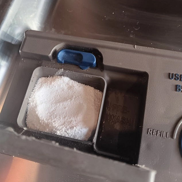 Close-up of Earthly Change Dishwasher Detergent packaging highlighting eco-friendly label and natural ingredient icons