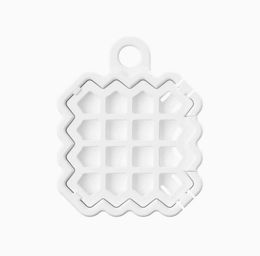 Close-up of the NATPAT Pet Locket’s textured silicone surface and engraved logo detail on the front side.