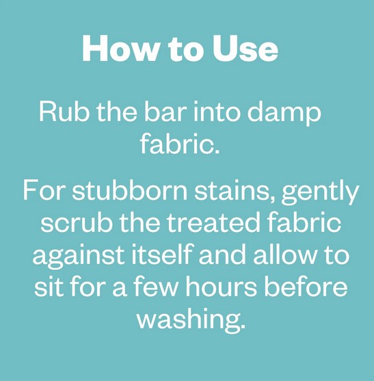 Close-up of the Etee Laundry Stain Stick tip showing textured white wax with embedded stain-removing granules.