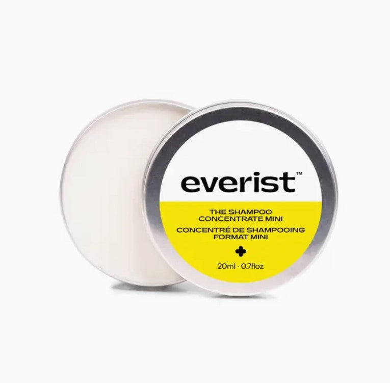 Close-up of the brushed tin surface and engraved logo on the Everist Shampoo Concentrate packaging detail