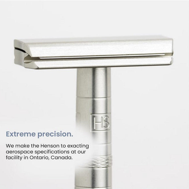 Close-up of the Henson AL13 Jet Black razor handle’s textured grip and engraved logo from an overhead angle