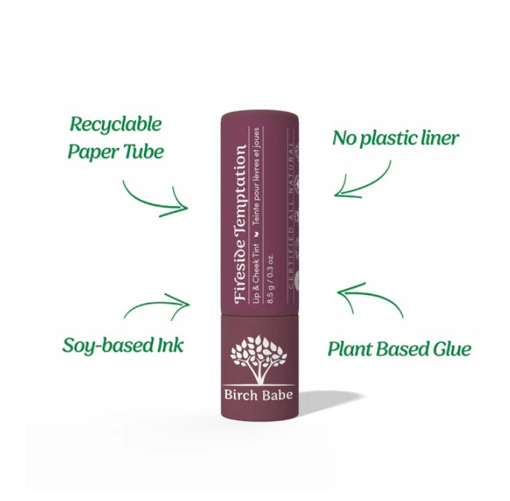 Close-up of the Fireside Temptation Lip & Cheek Tint tube displaying the Deep Burgundy matte label and textured matte finish