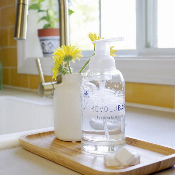 Revolubar Home foaming hand soap starter kit with clear glass bottle, organic soap concentrate tablets, and pump dispenser