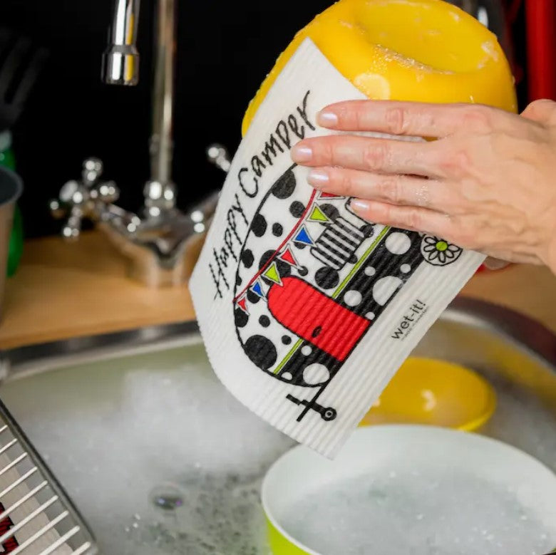 Close-up of the textured, honeycomb-patterned surface of the Happy Camper Wet It Cloth in vibrant teal, showing absorbent