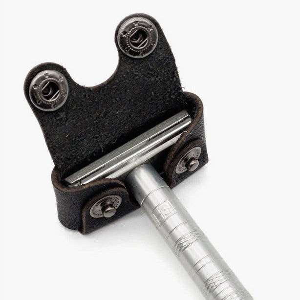 Henson Razor inserted into black leather head cover showing secure snap fastening