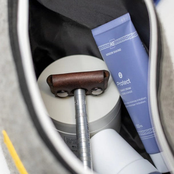Brown Henson Razor Head Cover packed inside travel dopp kit with shaving essentials