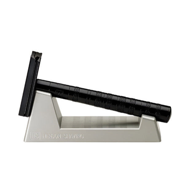 Close-up of the Henson Razor Stand’s matte black metal base with a chrome threading ring for secure razor placement and