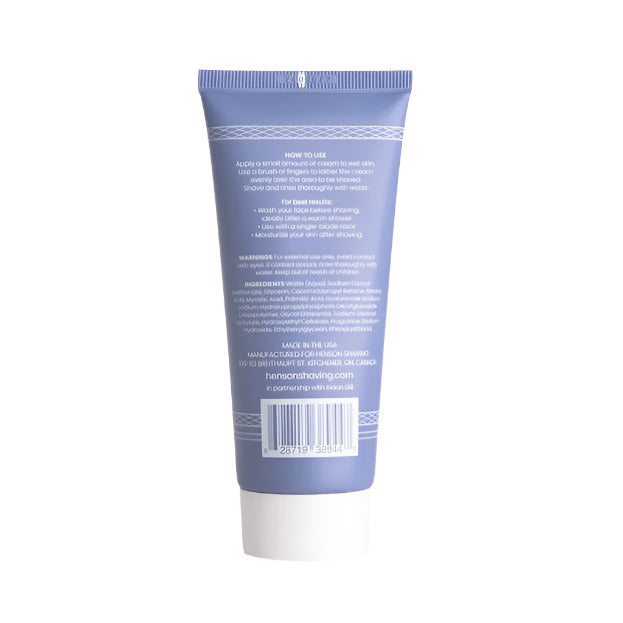 Close-up of Henson Shave Cream’s textured, creamy formula on a spoon, highlighting rich consistency and subtle herbal scent