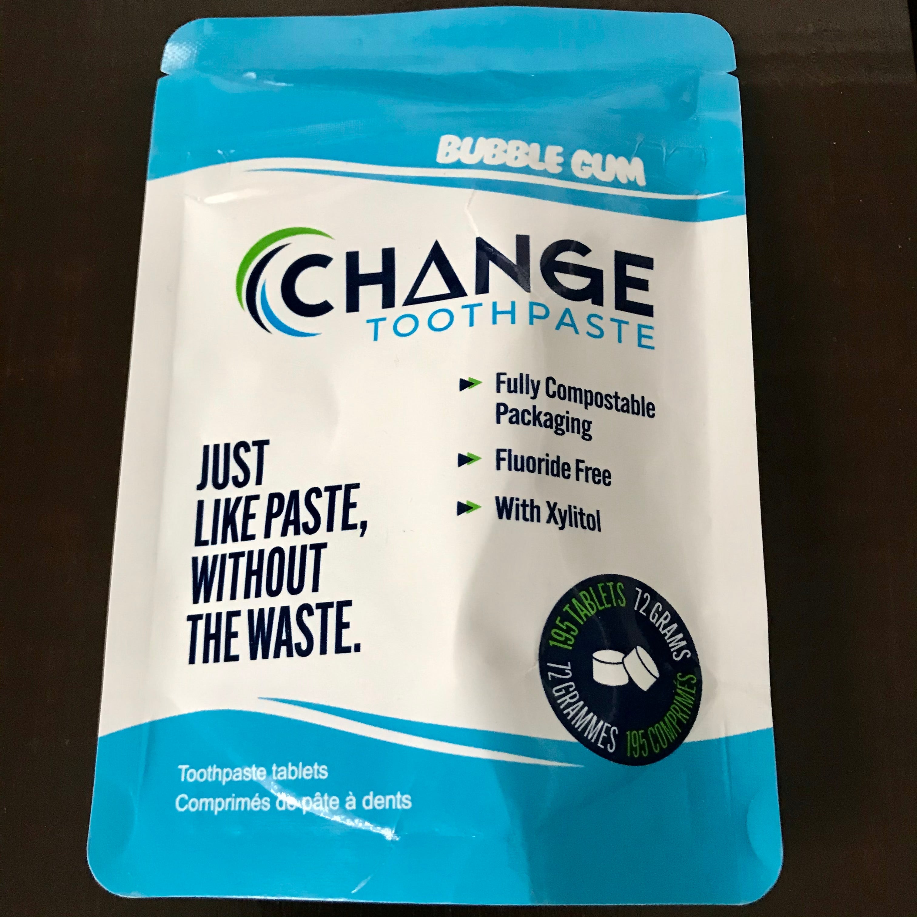 Close-up of the Bubble Gum flavored toothpaste tablet package showing the textured surface and vibrant pink color detail