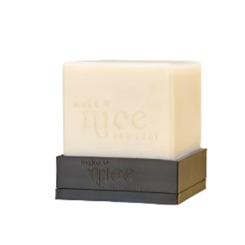 Close-up of the textured ceramic soap dish with drainage grooves and glossy white finish, angled to highlight its raised