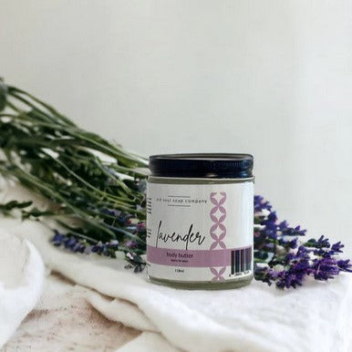 Jar of Canadian made lavender body butter with lavender flowers on a white background