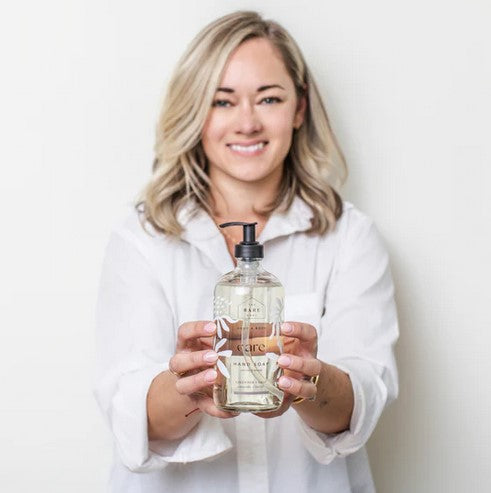 Close-up of lavender and sage botanicals on the soap label with textured surface detail; height 4 inches, cylindrical shape.