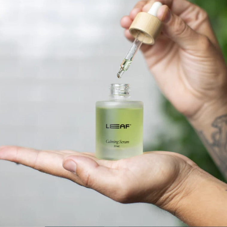 Close-up of the Leaf Shave Calming Serum dropper with clear, lightweight texture and soothing scent visible on the dropper