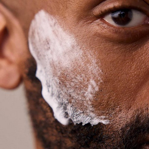 Close-up of a rectangular Leaf Shave Soap Bar showcasing its textured, natural plant-based ingredients with visible