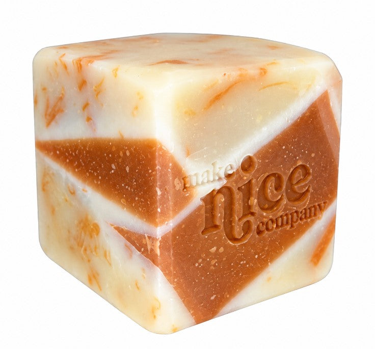 Unwrapped Mom's Simmering Pot Solid Dish Soap by Make Nice Company, featuring a unique cream and warm brown marbled cube with embossed logo, made from leftover soap trimmings.