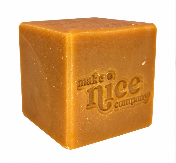 Unwrapped Make Nice Company Orange Clove Cinnamon Solid Dish Soap cube with embossed logo, natural vegan and palm oil-free dish soap made in Canada.