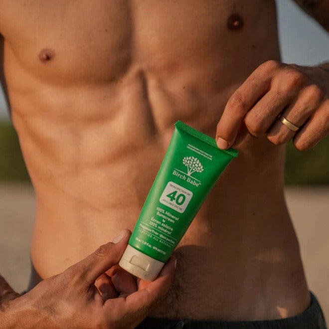 Man holding Birch Babe Mineral Sunscreen SPF 40 Fragrance Free – natural Canadian-made mineral sunscreen for sensitive skin.