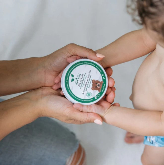 Close-up of Birch Baby Diaper Balm jar displaying textured, easy-to-apply formula and gentle scent on smooth, natural paper